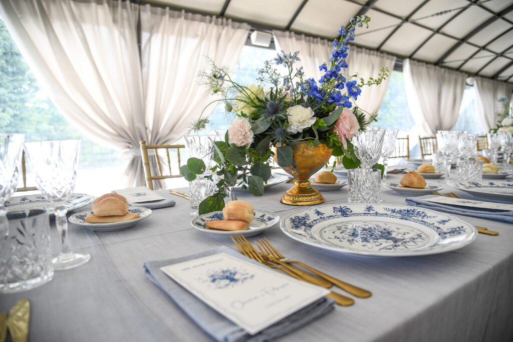 Elegant destination wedding table in Italy with floral centerpiece and blue and white tableware