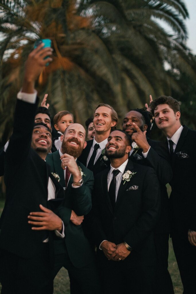 Friends taking a selfie together at a destination wedding