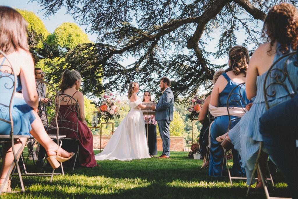 Outdoor symbolic wedding ceremony in Italy with couple and guests