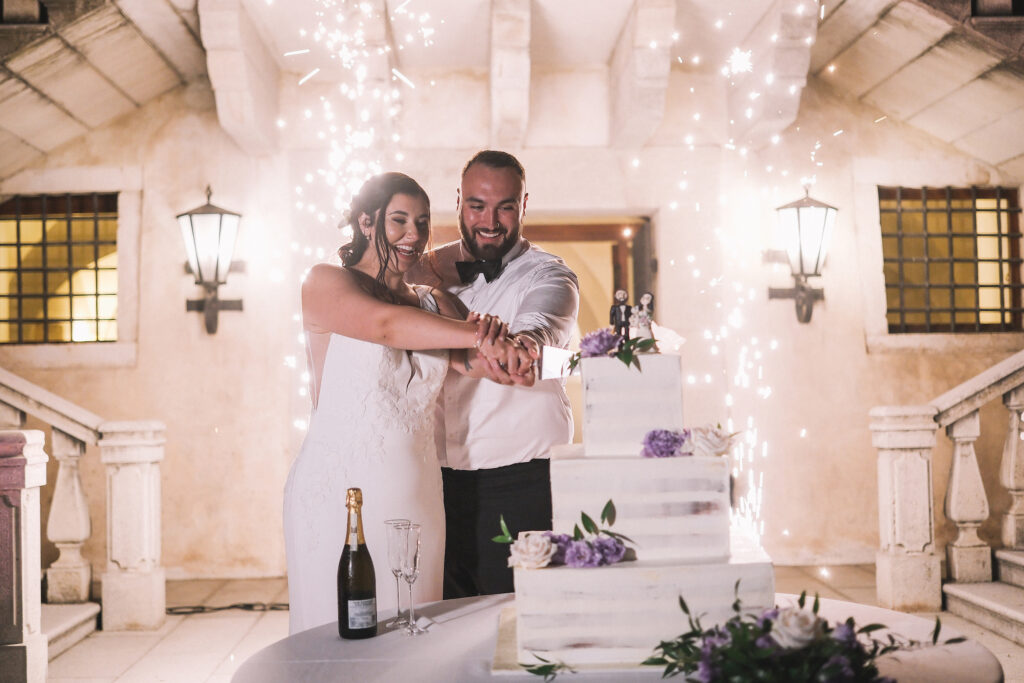 Lauren and Bill cutting their wedding cake at Castello di Susans in Friuli, Italy